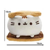 A white plush cat doll with orange ears and a brown base, shown against a measurement scale.