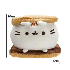 A white plush cat doll with orange ears and a brown base, shown against a measurement scale.