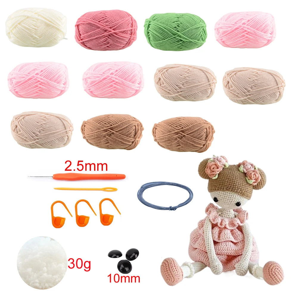 A collection of yarn balls and crochet tools for making an amigurumi doll, including various colors and a finished doll.