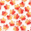 A set of 50 small, translucent red and orange cherry blossom flower glass beads for jewelry making