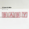 Pink acrylic letter cake toppers spelling BABY in white and pink colors