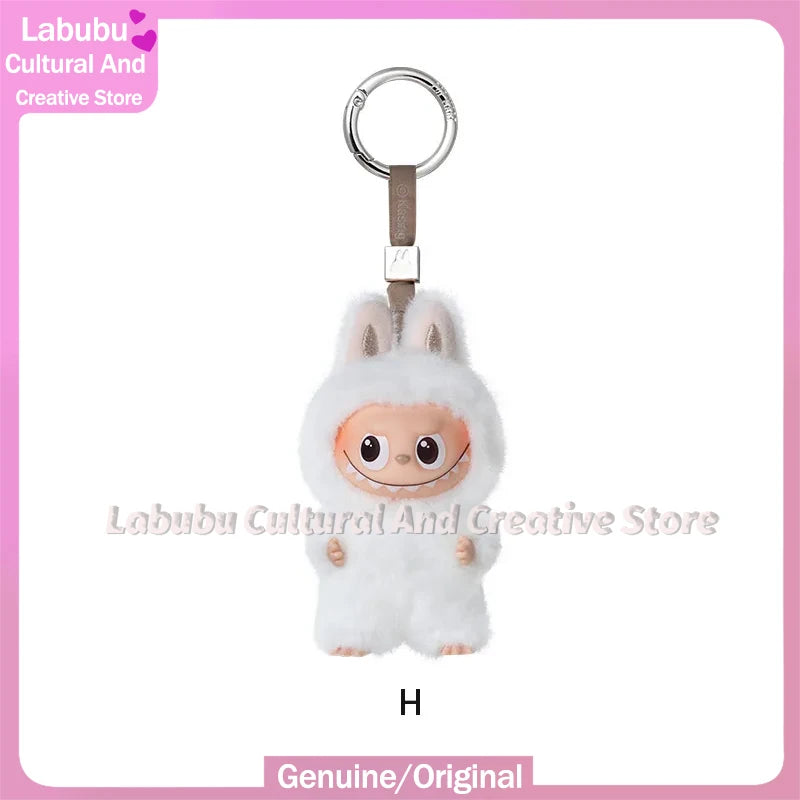A white fluffy Labubu plush doll with long ears and a silver keychain attached.