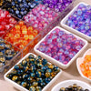 A collection of gradient crystal glass beads with a golden crackle finish in various colors and shapes.