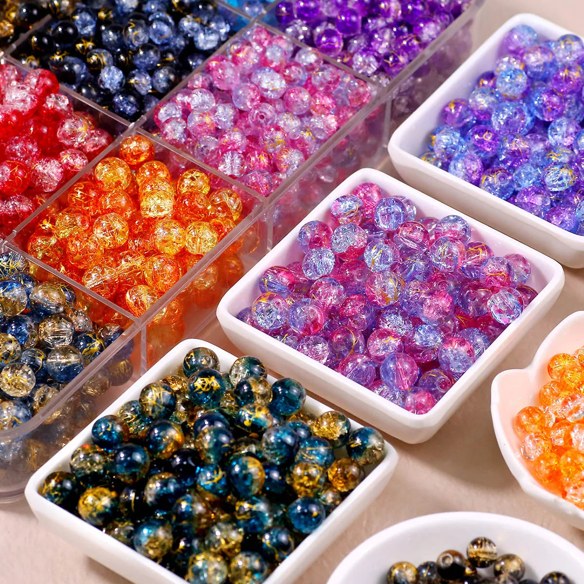 A collection of gradient crystal glass beads with a golden crackle finish in various colors and shapes.