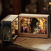 A wooden miniature dollhouse kit featuring furniture and lighting displayed inside a box.