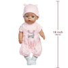 A pink baby doll wearing a matching outfit with a cat print shirt and a pink hat.