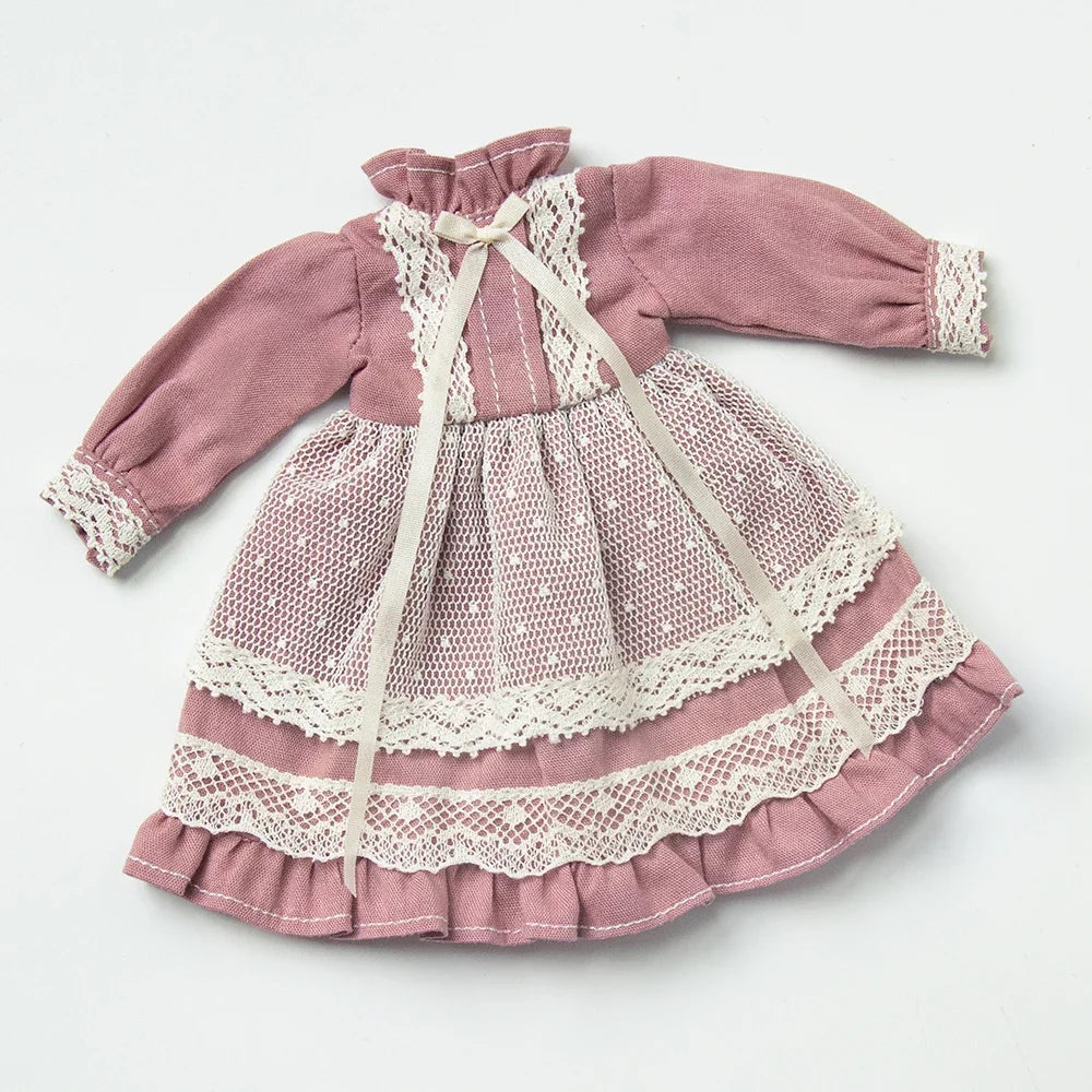 A vintage lace maid dress set for 1/6 scale dolls in dusty rose pink with white lace trim.