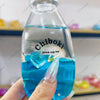 A hand holds a clear bottle labeled Chiboki, which contains blue liquid and ice cubes, used as a drink cup toy.