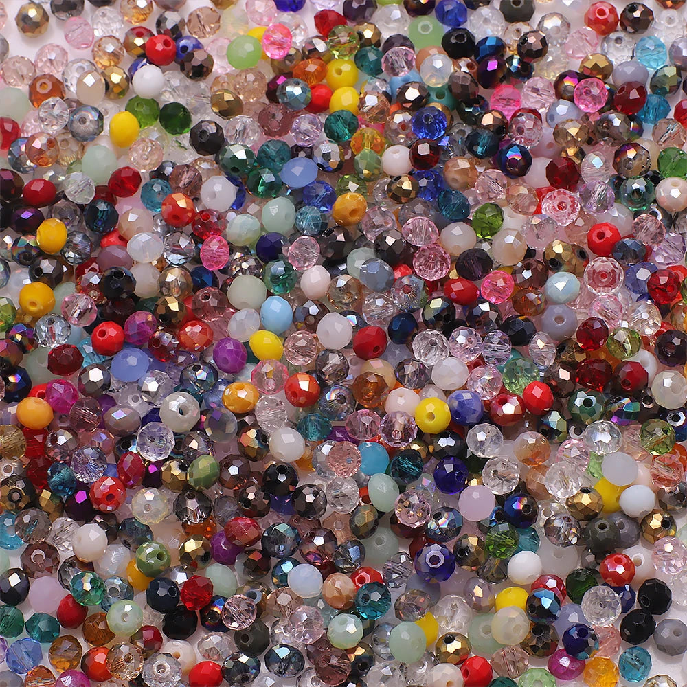 A close-up view of a colorful mix of faceted crystal rondelle glass beads for jewelry making