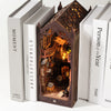 A DIY book nook kit featuring miniature furniture and a detailed diorama inside a wooden house structure.