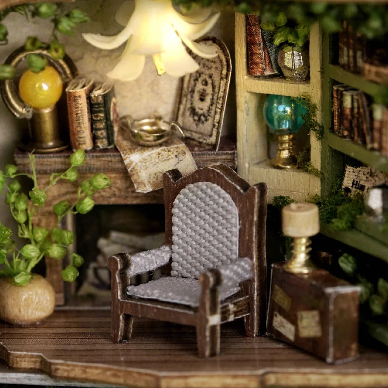 A wooden miniature dollhouse kit featuring furniture and lighting elements displayed on a shelf.