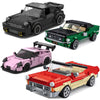A set of three die-cast model cars in black, green, and pink colors.