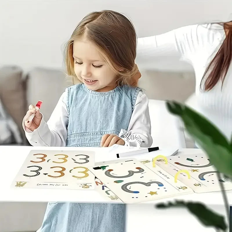 A young girl is drawing in a reusable magic drawing workbook with pens and an eraser.