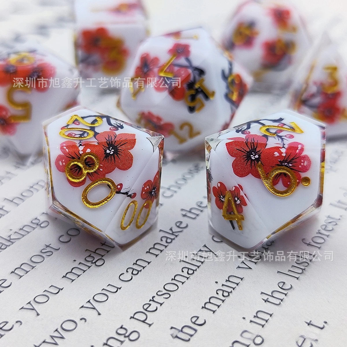 A set of milk white resin dice featuring a black kitten design with red floral accents.