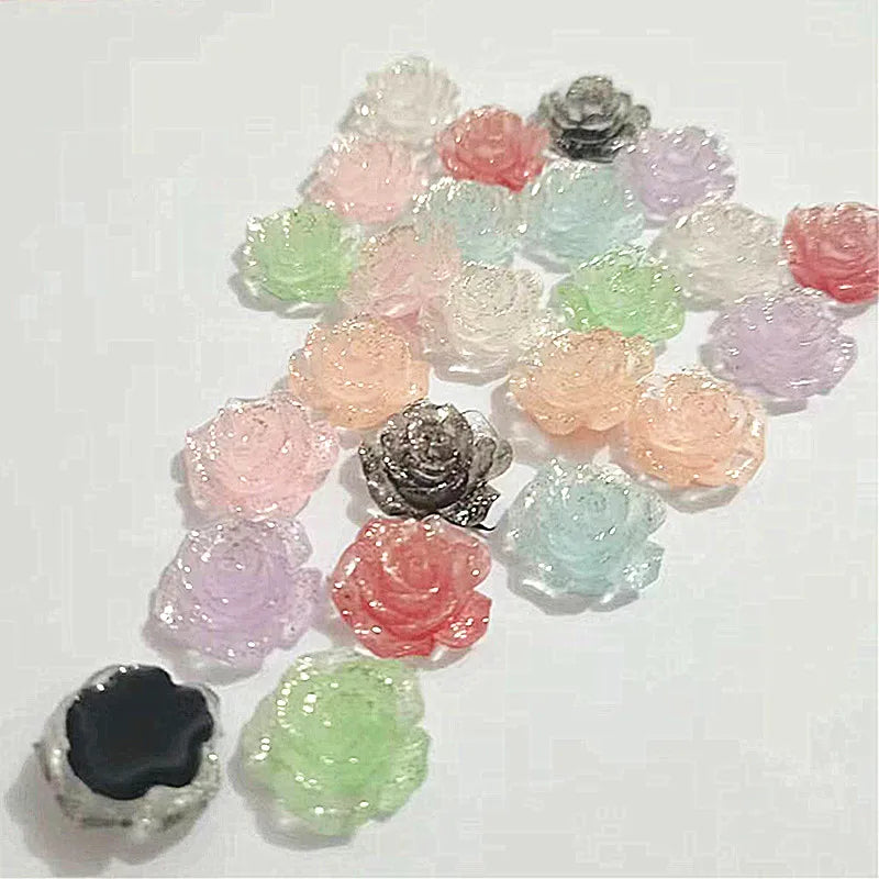 A collection of 50 small, colorful rose-shaped resin flatback flowers in various shades of pink, purple, and green.