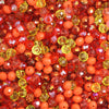 A close-up view of multicolor round crystal glass beads in shades of orange, red, and yellow.