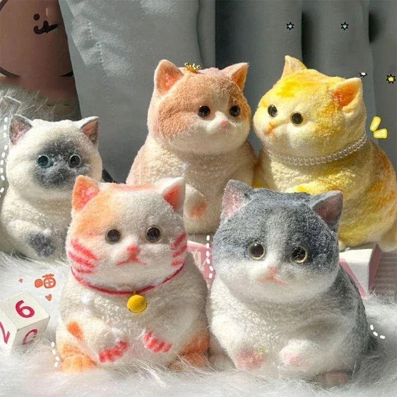 A collection of fluffy, flocked cat sensory fidget toys in various colors including orange, yellow, and gray.