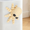 A light beige 3D printed articulated octopus fridge magnet with black eyes