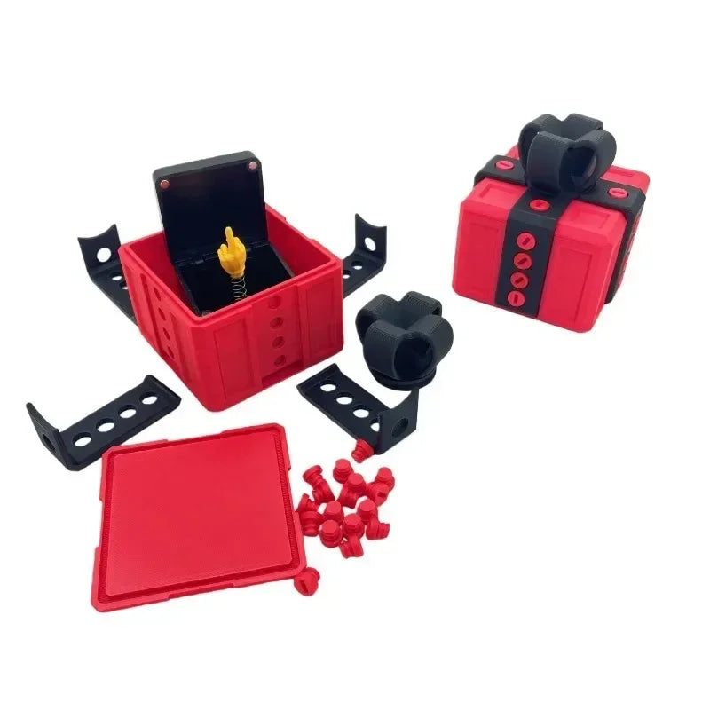 A red pop-up surprise gift box with a black lid and screws visible.