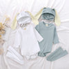 A set of white and light blue rabbit themed clothing for babies, including a romper, hat, and socks.