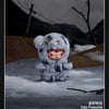 A fluffy gray and white plush doll resembling a bear is shown in a snowy outdoor setting.