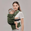 A woman is holding a baby in an adjustable cotton wrap carrier.