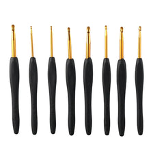 A set of eight ergonomic crochet hooks with gold tips and black grips.