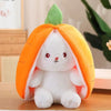 A white plush bunny toy shaped like an orange fruit with green leaves.