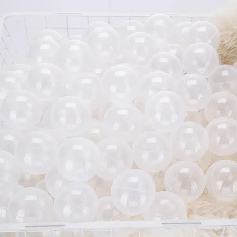 A white plastic basket filled with a large quantity of clear, round, inflated play balls.