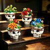 A set of white building blocks shaped like skulls decorated with colorful floral arrangements and foliage.