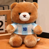 A fluffy brown teddy bear wearing a light blue and white striped football jersey with the number 10