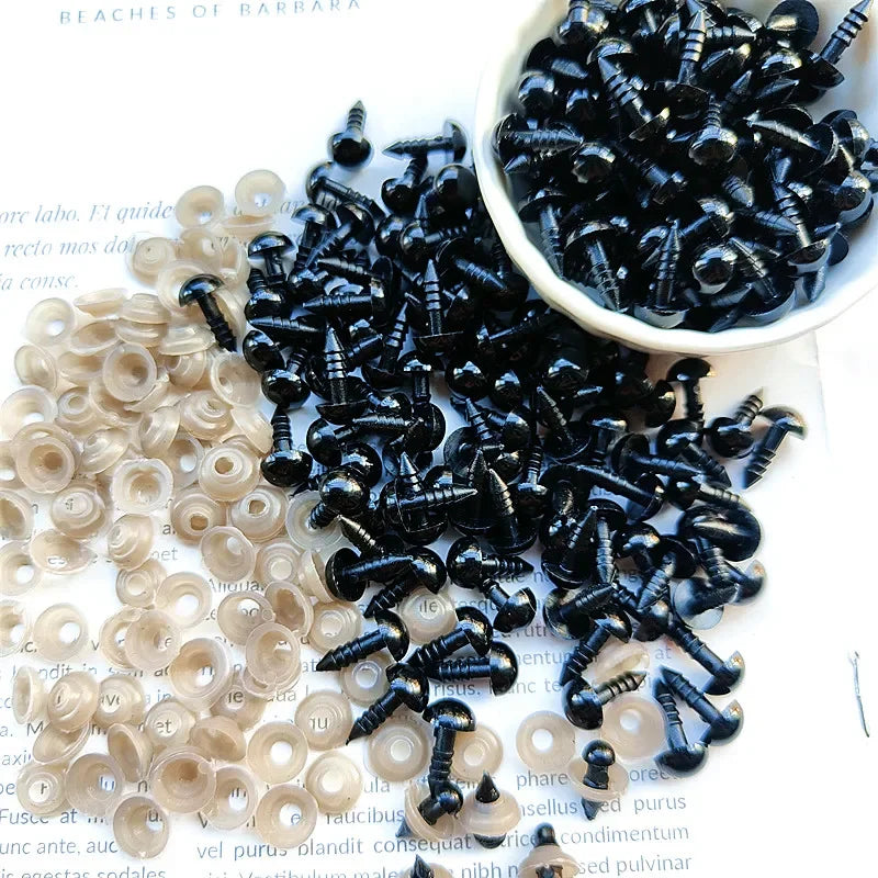A collection of black and clear plastic safety eyes for crafting, including a bowl full of the eyes.