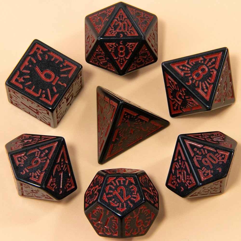 A set of seven fantasy carved polyhedral dice in black and red on a beige surface.