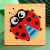 A wooden puzzle featuring a colorful ladybug design with black, red, and blue sections.
