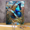 A painting in progress of a blue butterfly on a floral canvas, surrounded by grasses and foliage.