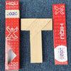 A wooden tangram puzzle with geometric shapes is shown against a dark blue background.