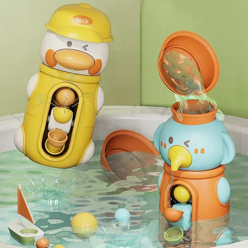 A yellow duck bath toy is shown next to a blue elephant bath toy, both featuring suction cup waterwheels in a clear tub.