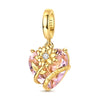 A gold-toned heart charm bead featuring a pink gemstone and a yellow floral design.
