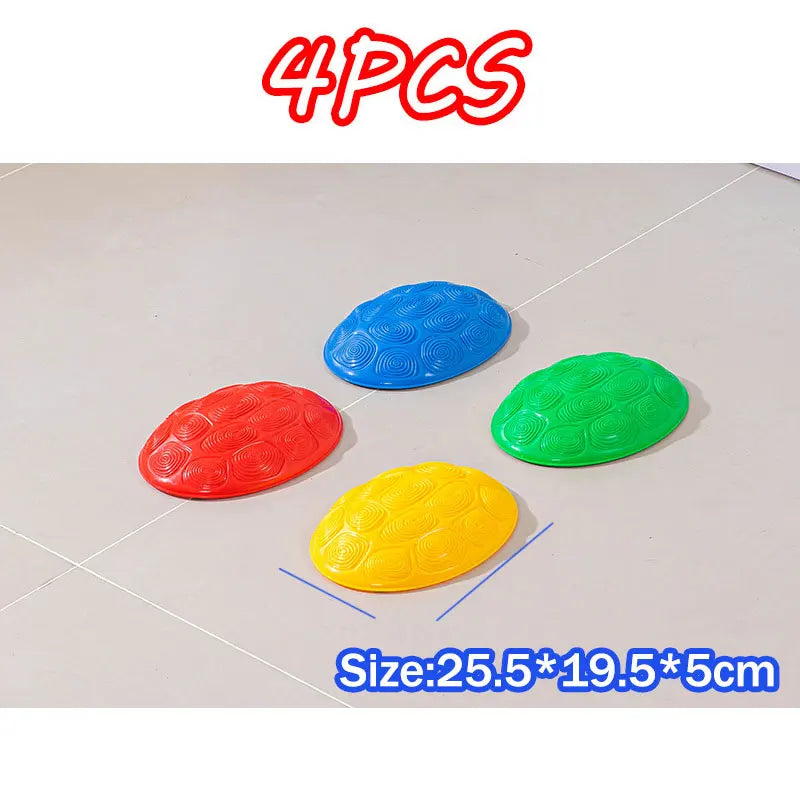 Four colorful balance stones in red, blue, green, and yellow are displayed on a white surface.