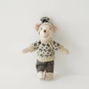 A handmade mouse plush doll wearing a knitted outfit and plaid shorts.
