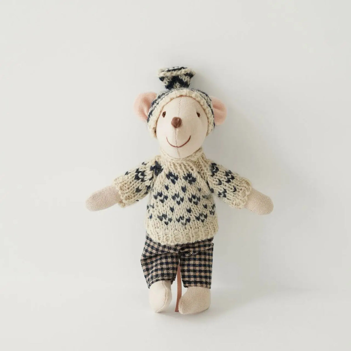 A handmade mouse plush doll wearing a knitted outfit and plaid shorts.