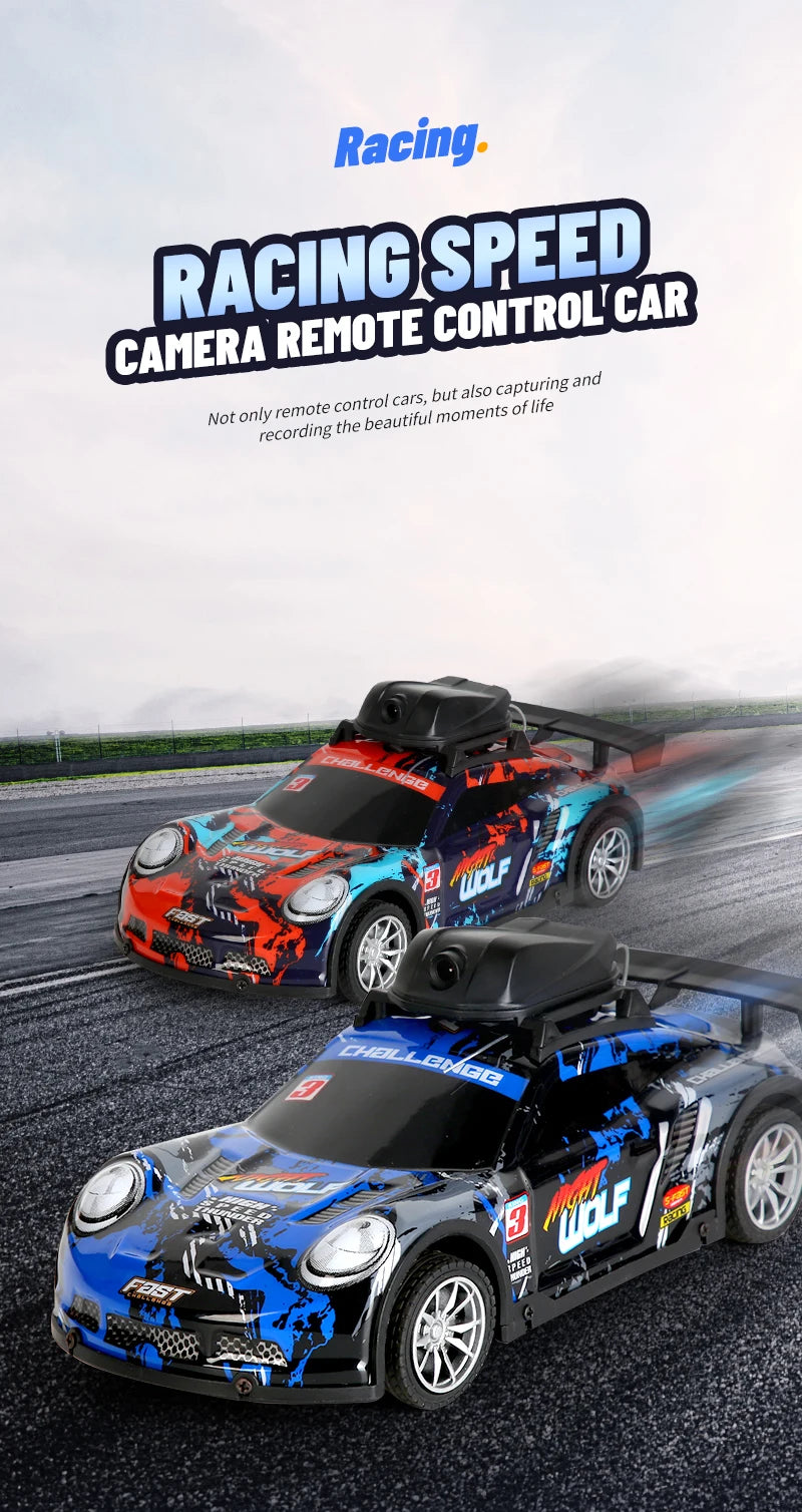 Two racing speed camera remote control cars in blue and orange are shown on an asphalt track.