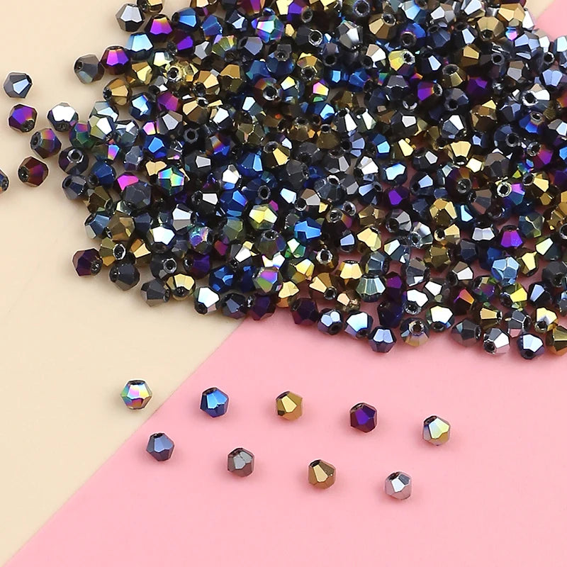 A pile of iridescent crystal glass beads in various sizes and colors, including purple, blue, gold, and black, scattered on a