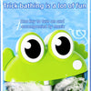 A bright green frog bath toy with large eyes is shown in a bathtub filled with soapy water.