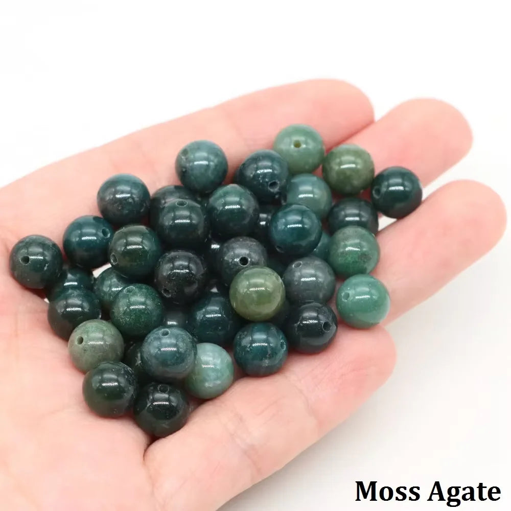 A handful of dark green Moss Agate round beads for jewelry making