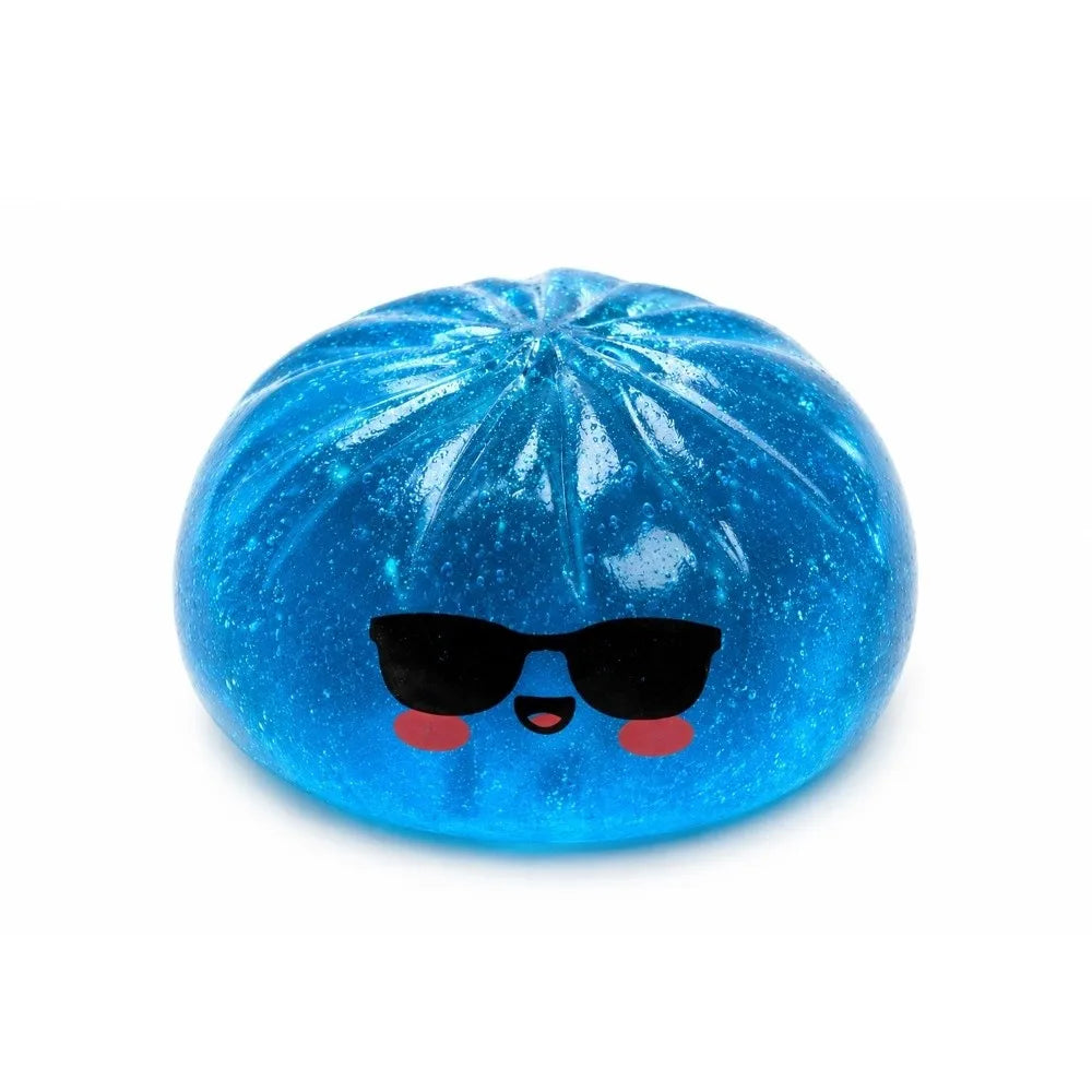 A bright blue glitter shark dumpling squishy fidget toy with a steamer box.