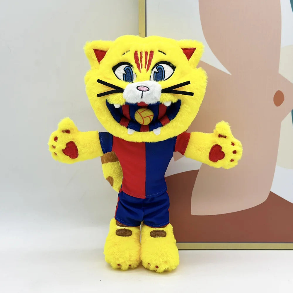A yellow cat mascot plush toy with striped fur and a football emblem on its chest.