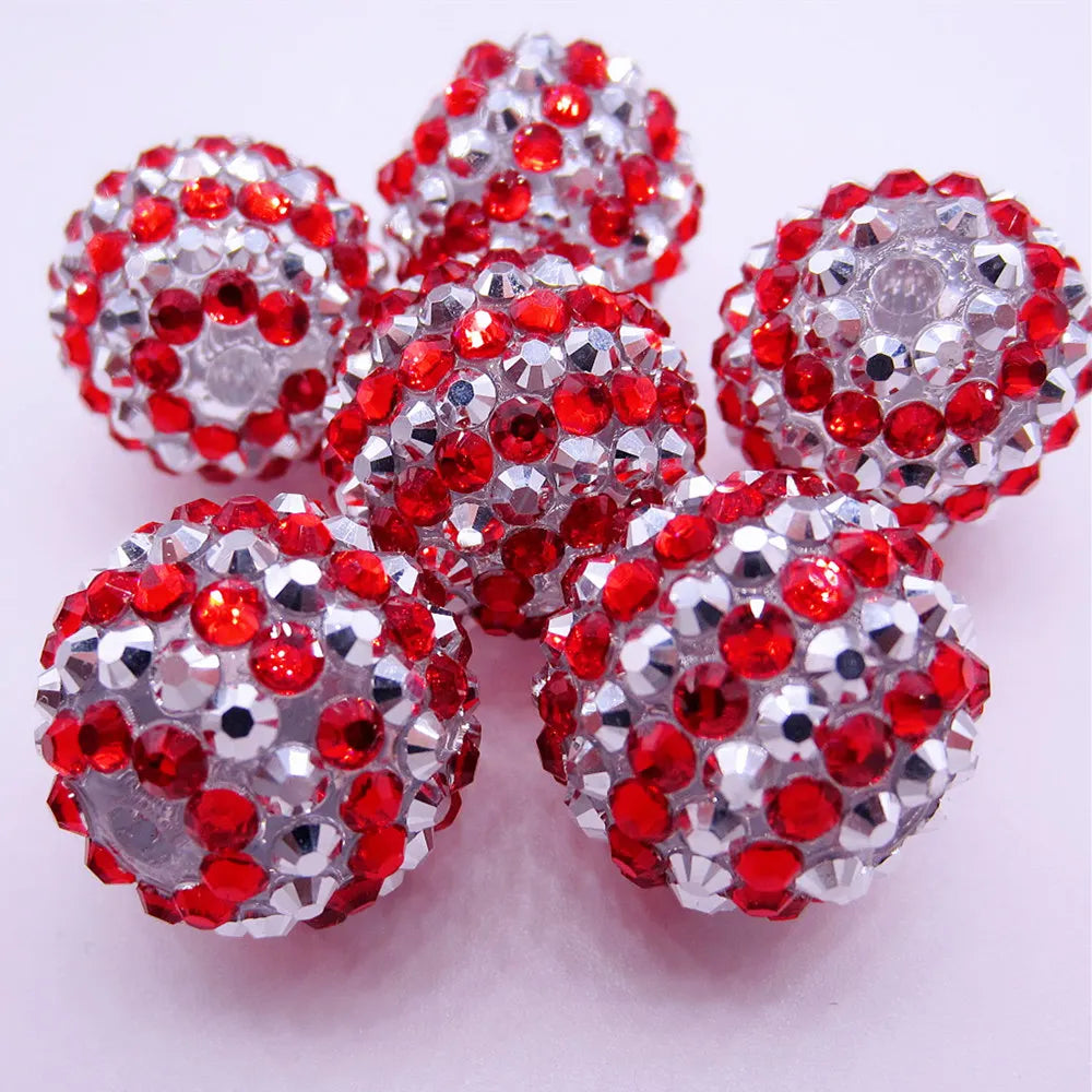 A cluster of red and silver mixed two-tone striped resin beads for jewelry making