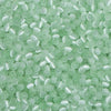A close-up view of a colorful mix of 4mm cat eye glass beads used for jewelry making.