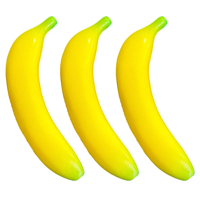 Three bright yellow banana-shaped stress relief toys